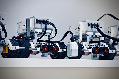 two white and black electronic device with wheels